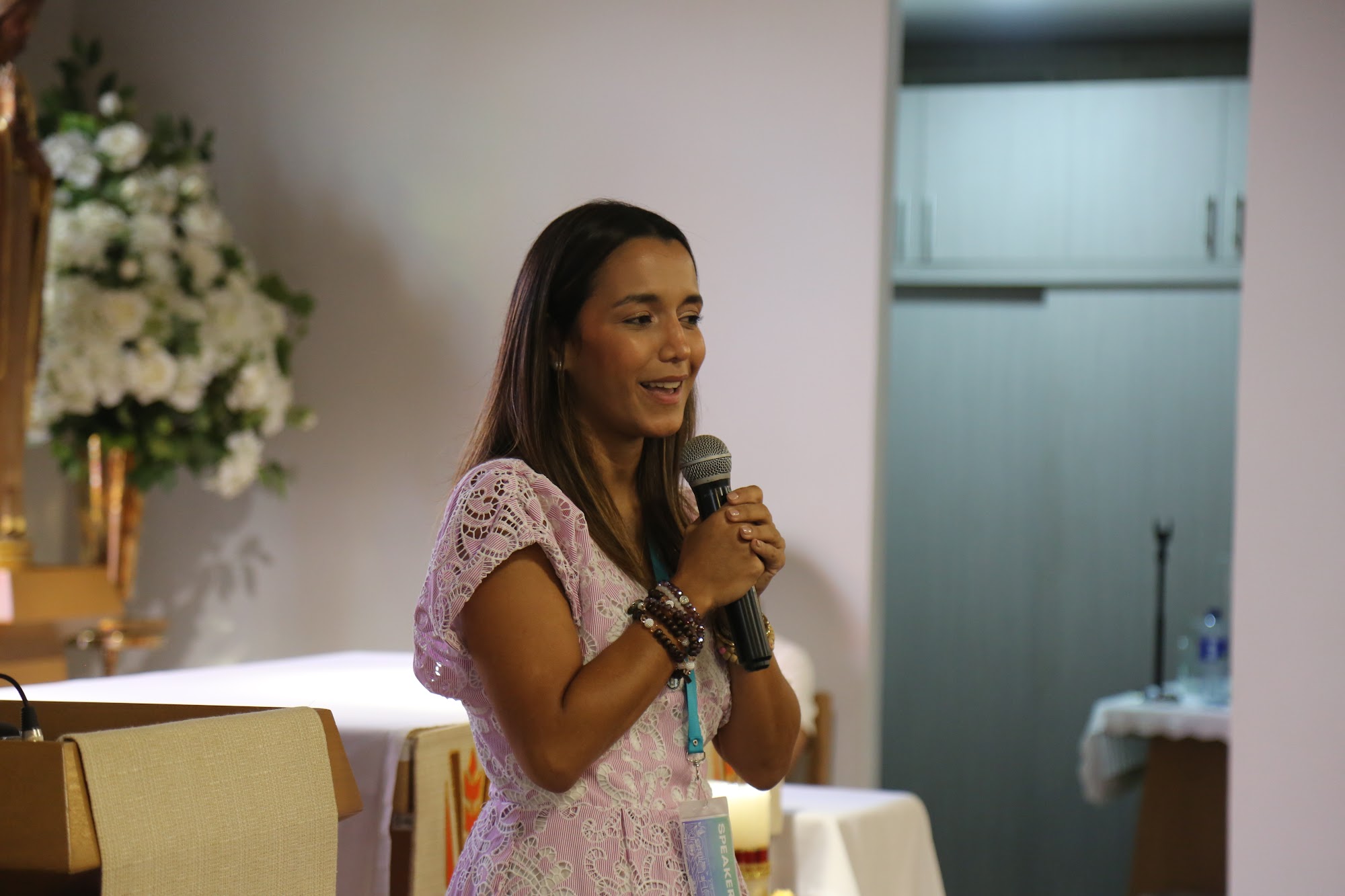 A student speaks into a microphone during the opening ceremony.