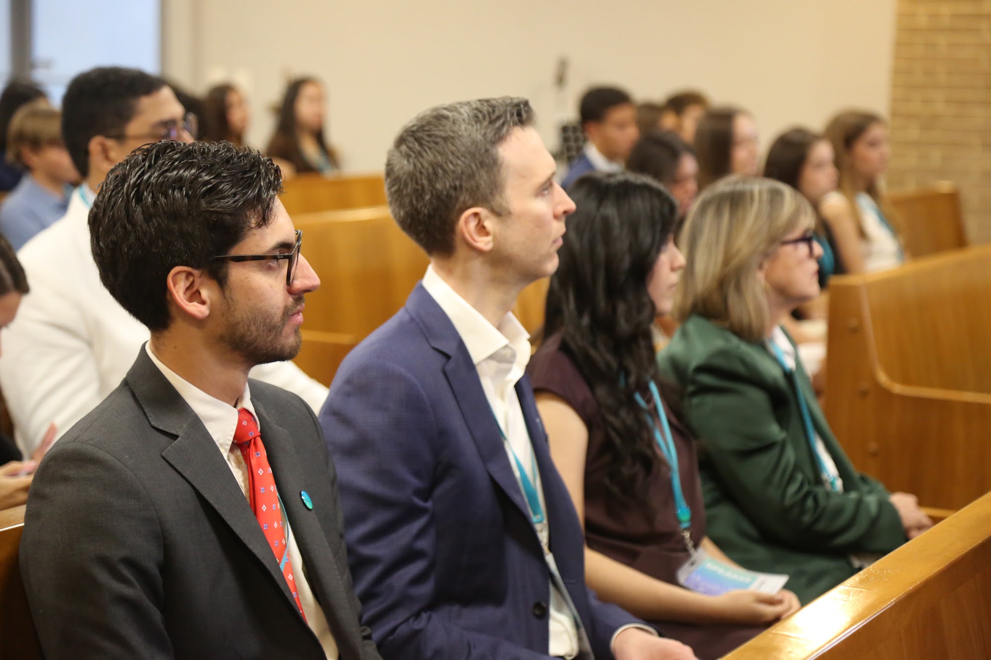 Staff and guests seated in the chapel during the opening.