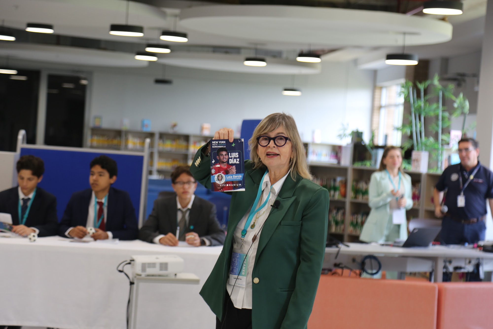 A member of staff presenting to the group in the library.