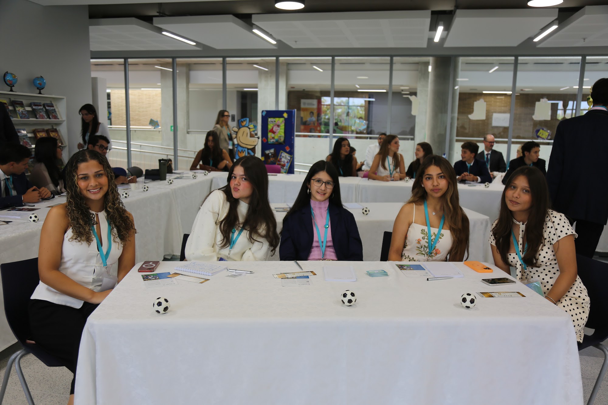 A row of students at their table during a session.