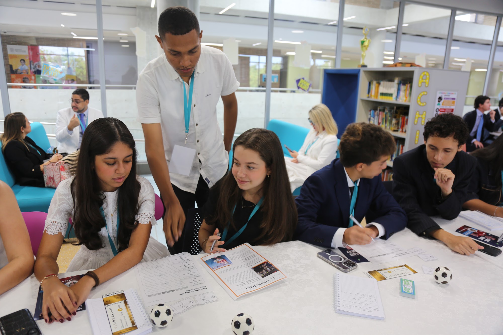 A mentor helping a table of students with the exercise.