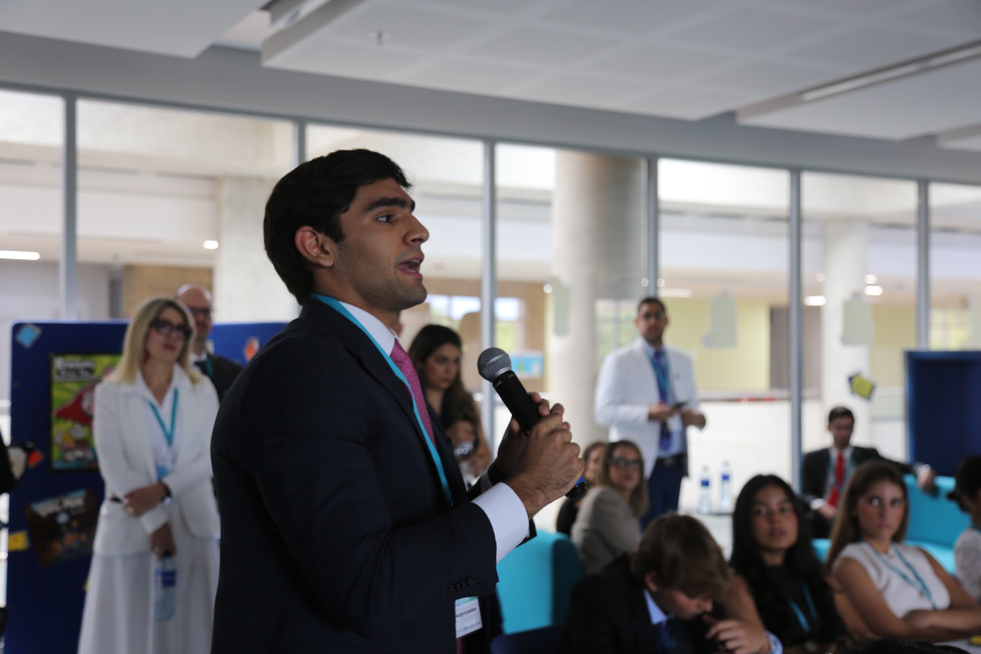 A student standing to ask a question during a talk.
