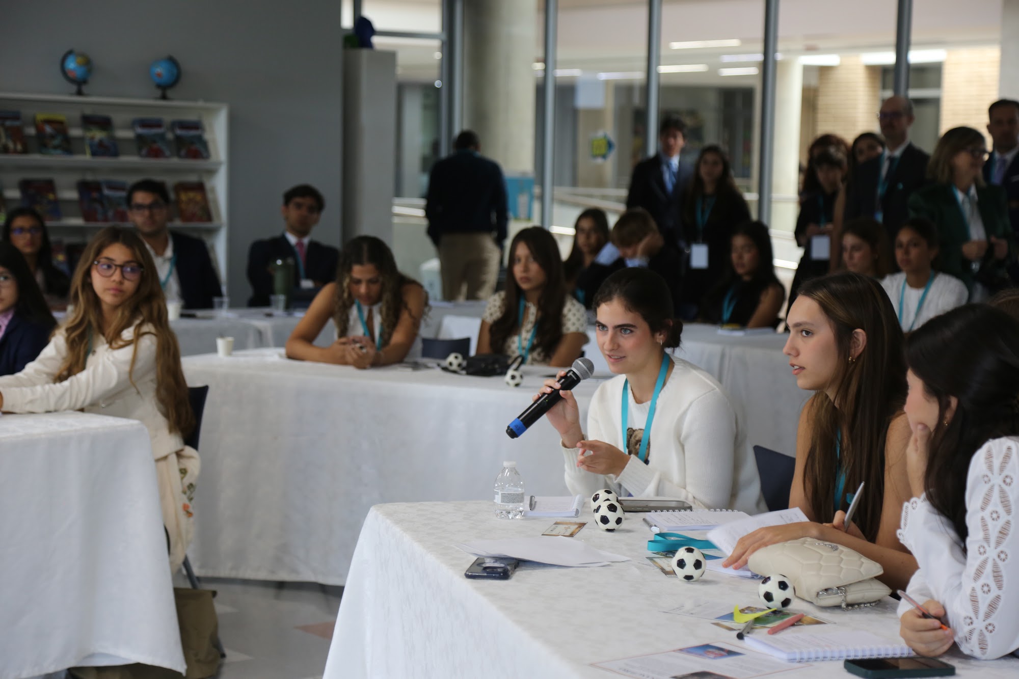 A student asking a question with the microphone.
