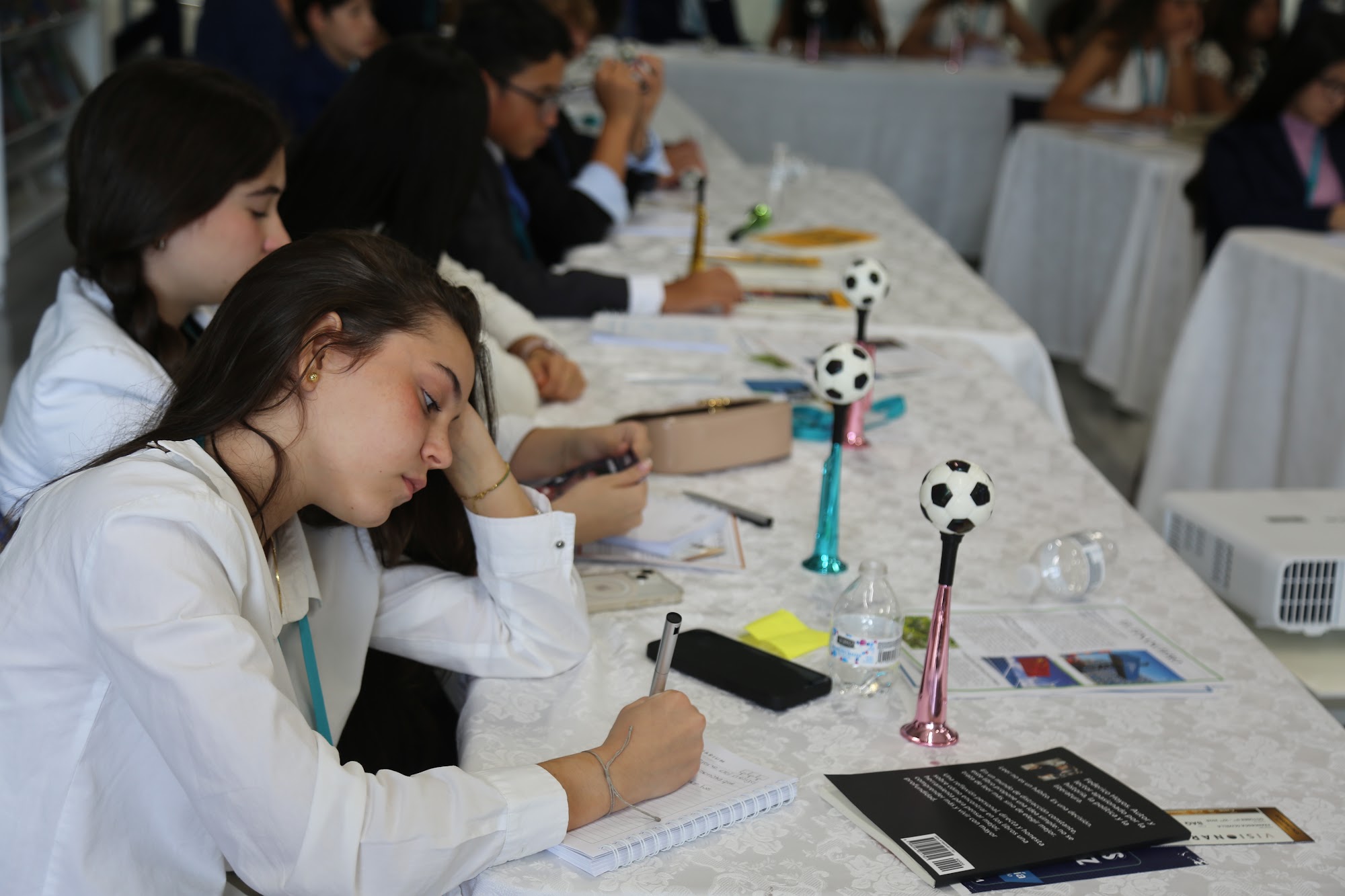 Students working through an exercise at their table.