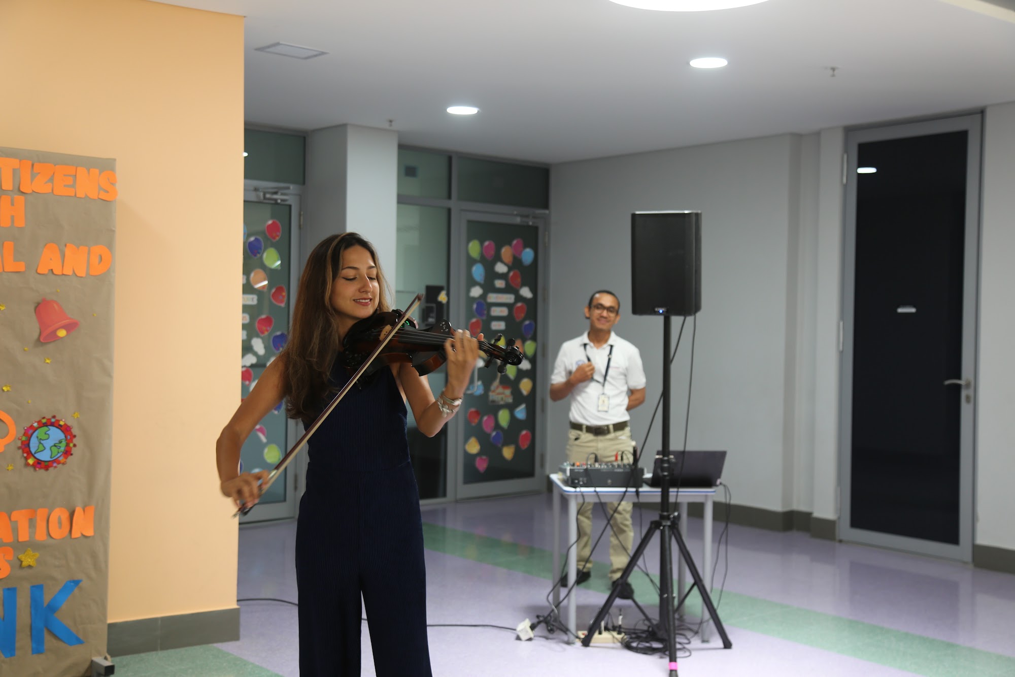 A violinist playing in the corridor between sessions.