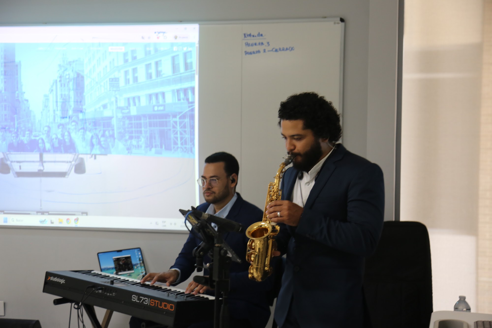 A saxophone and keyboard duo playing during lunch.