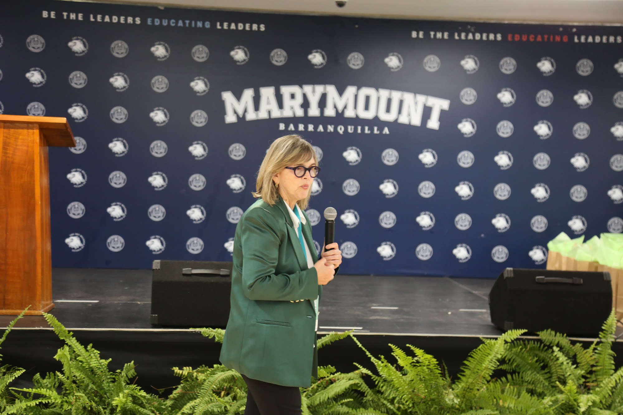 A member of staff addressing the group from the stage.