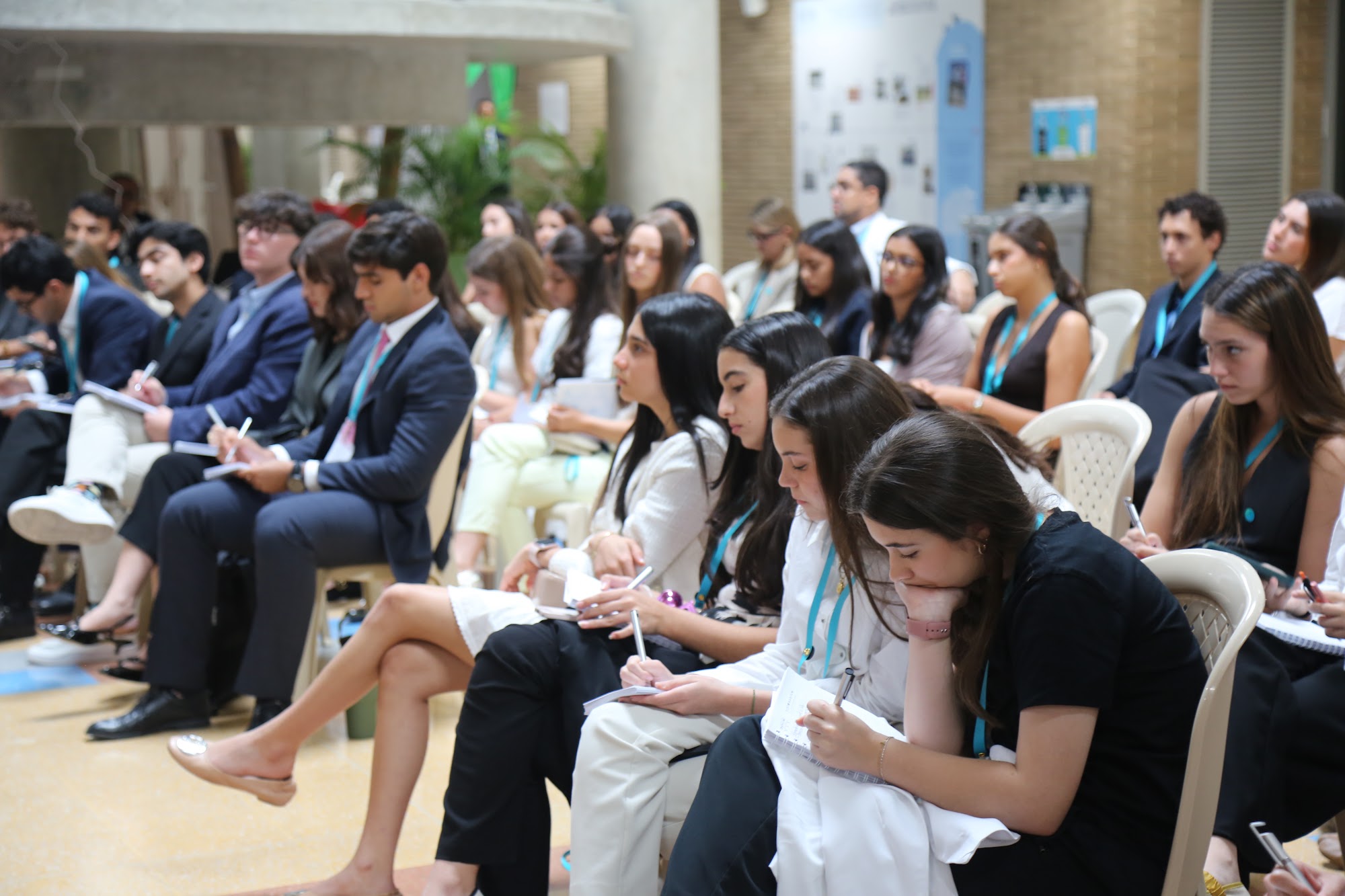 Students taking notes during the public speaking session.