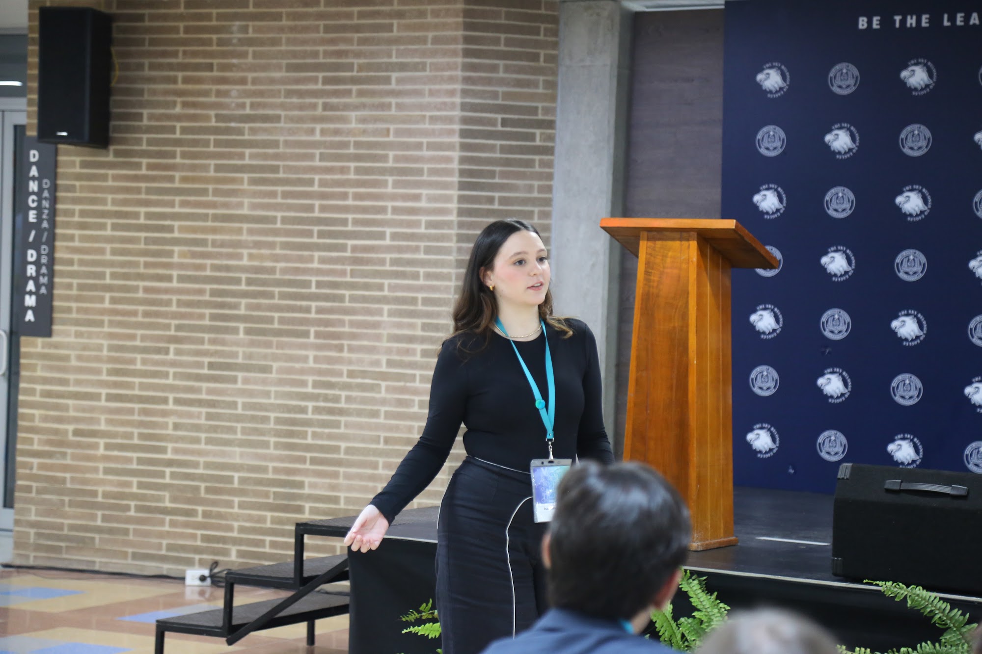 A student delivering her speech on stage.